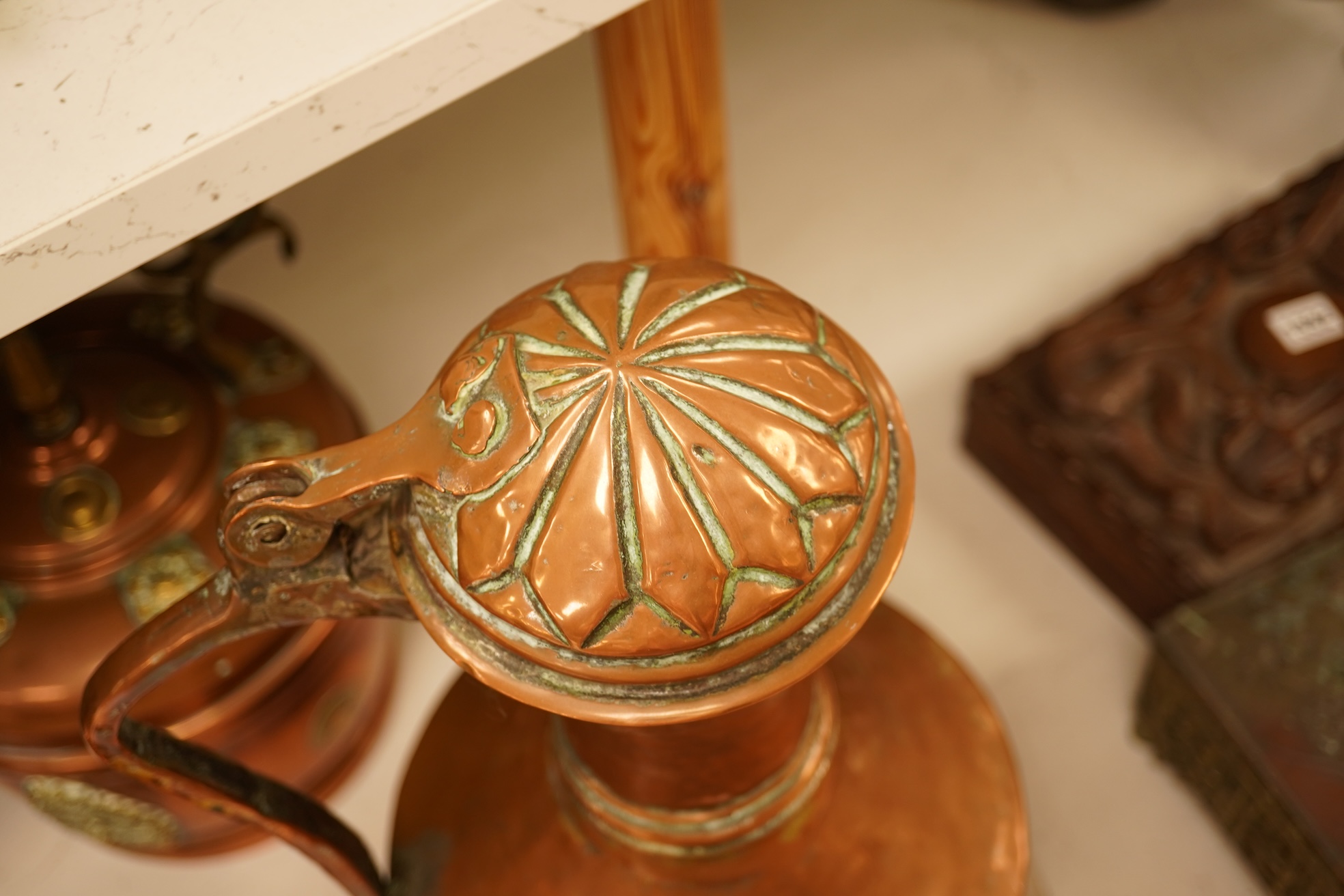 Four various copper vessels and a brass teapot, tallest 47cm